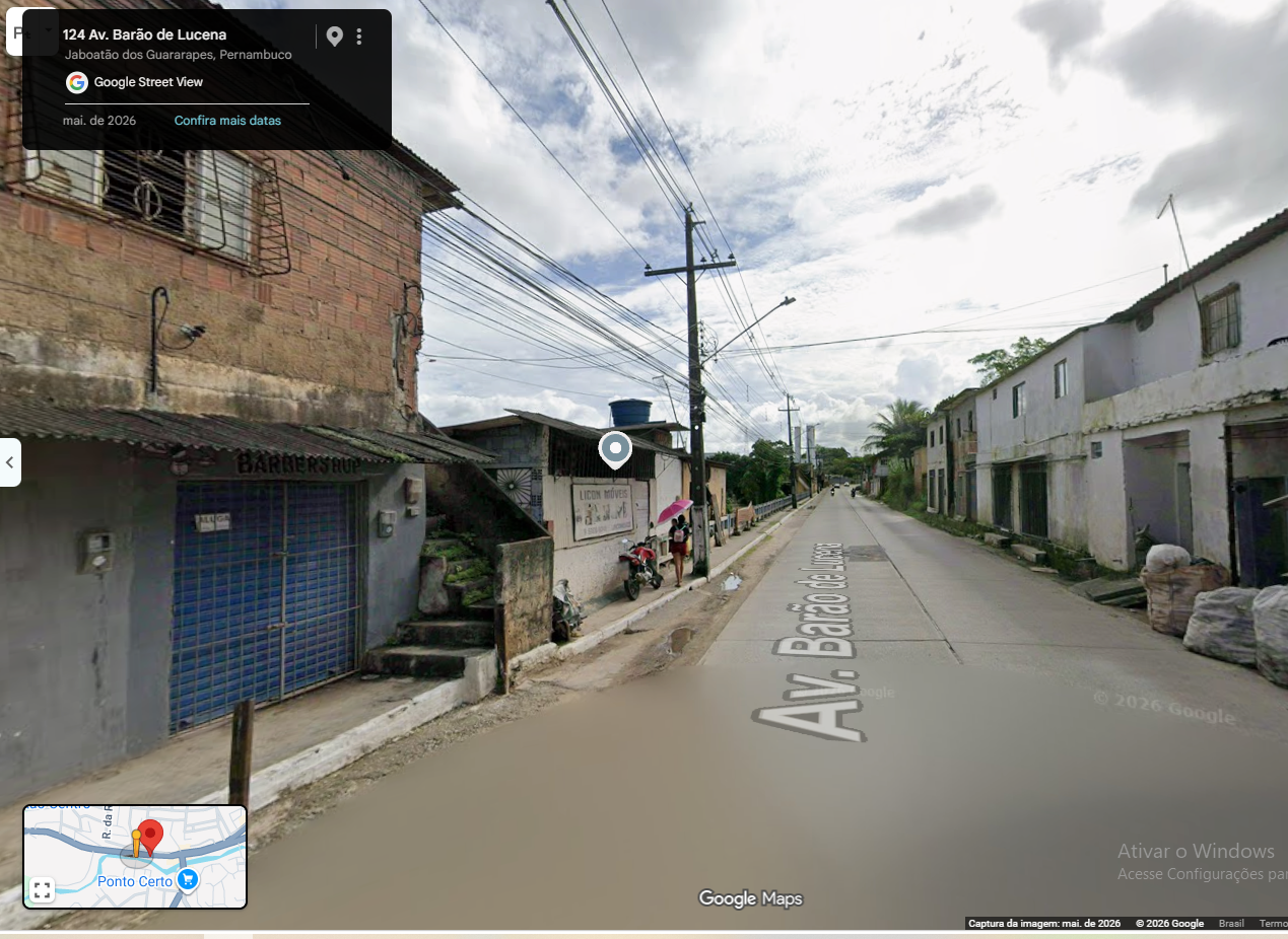 Fachada da barbearia, com grade e porta azul à esquerda da Lincon Móveis